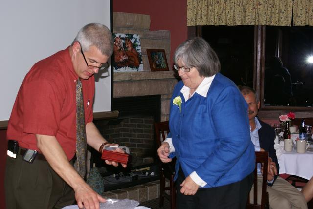 Dianne Tkach receives award on behalf of Mary Brown for her service as Secretary from Chief Keough